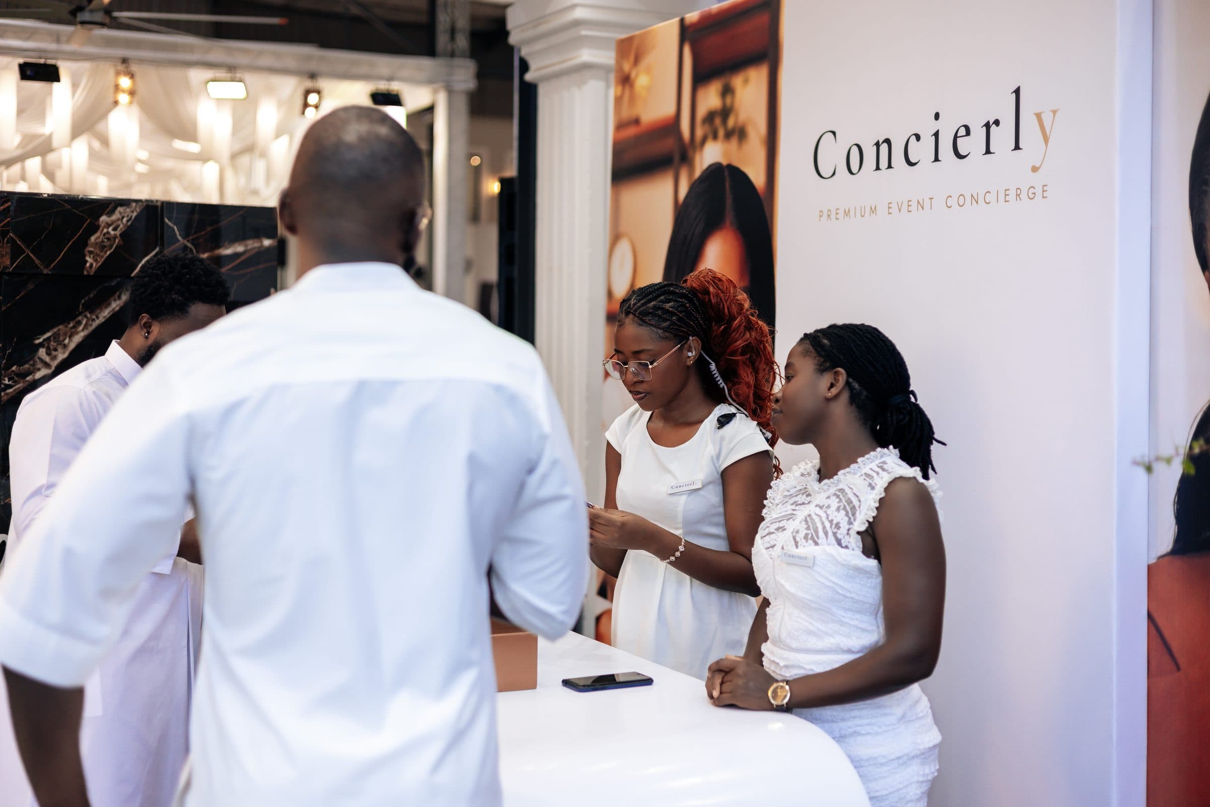 Concierly concierge hosts assisting a guest at a premium event
